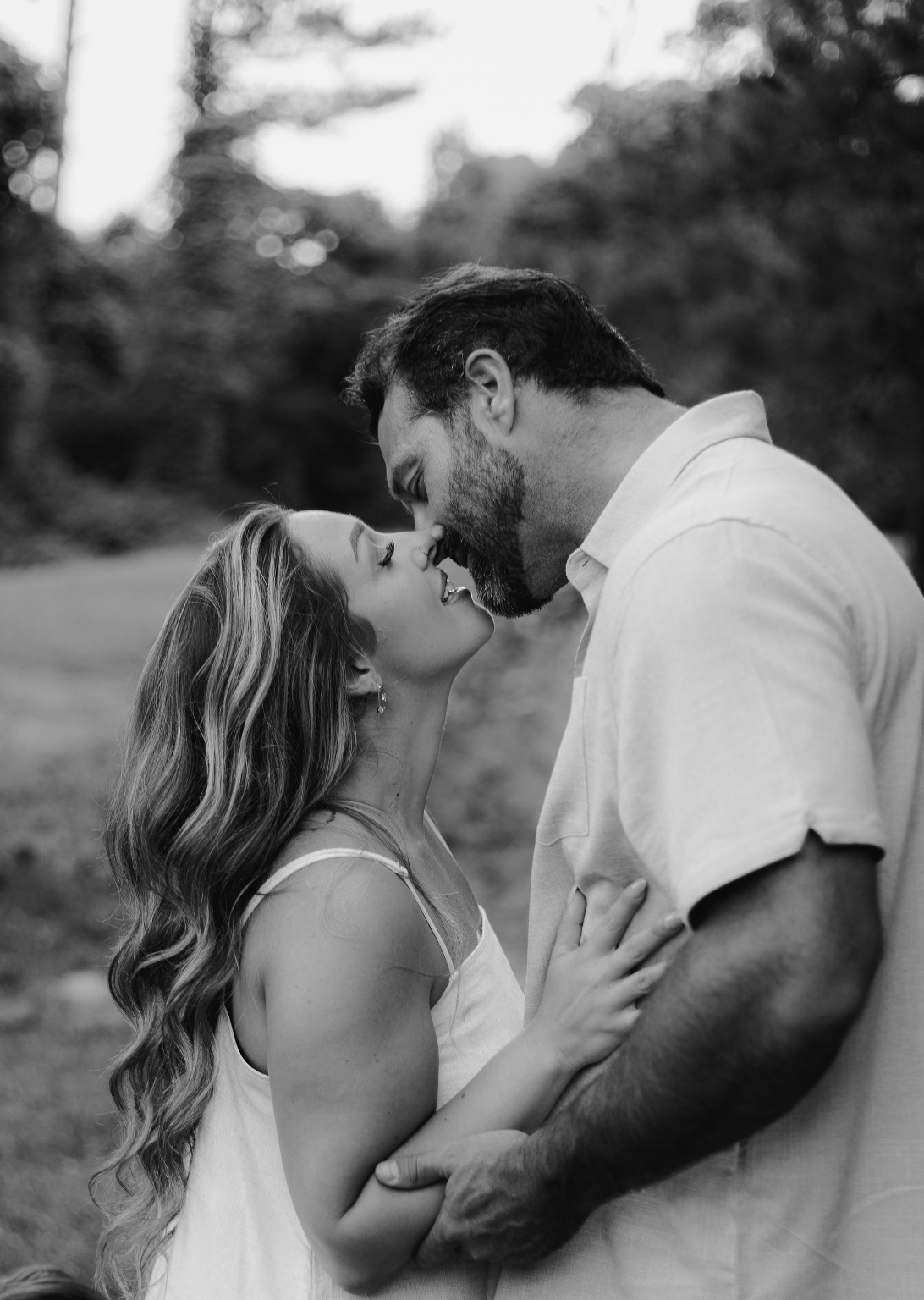 A couple sharing a quiet kiss in black and white