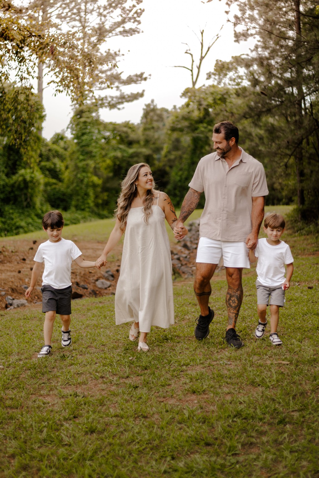 A family laughing and running together outdoors