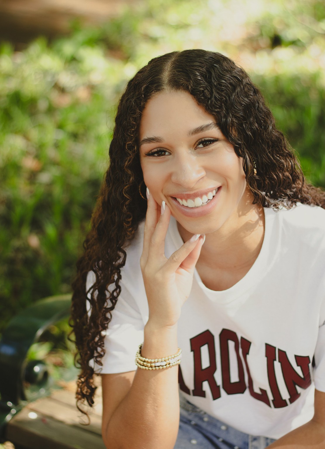 A close smiling portrait of Layla in Carolina colors