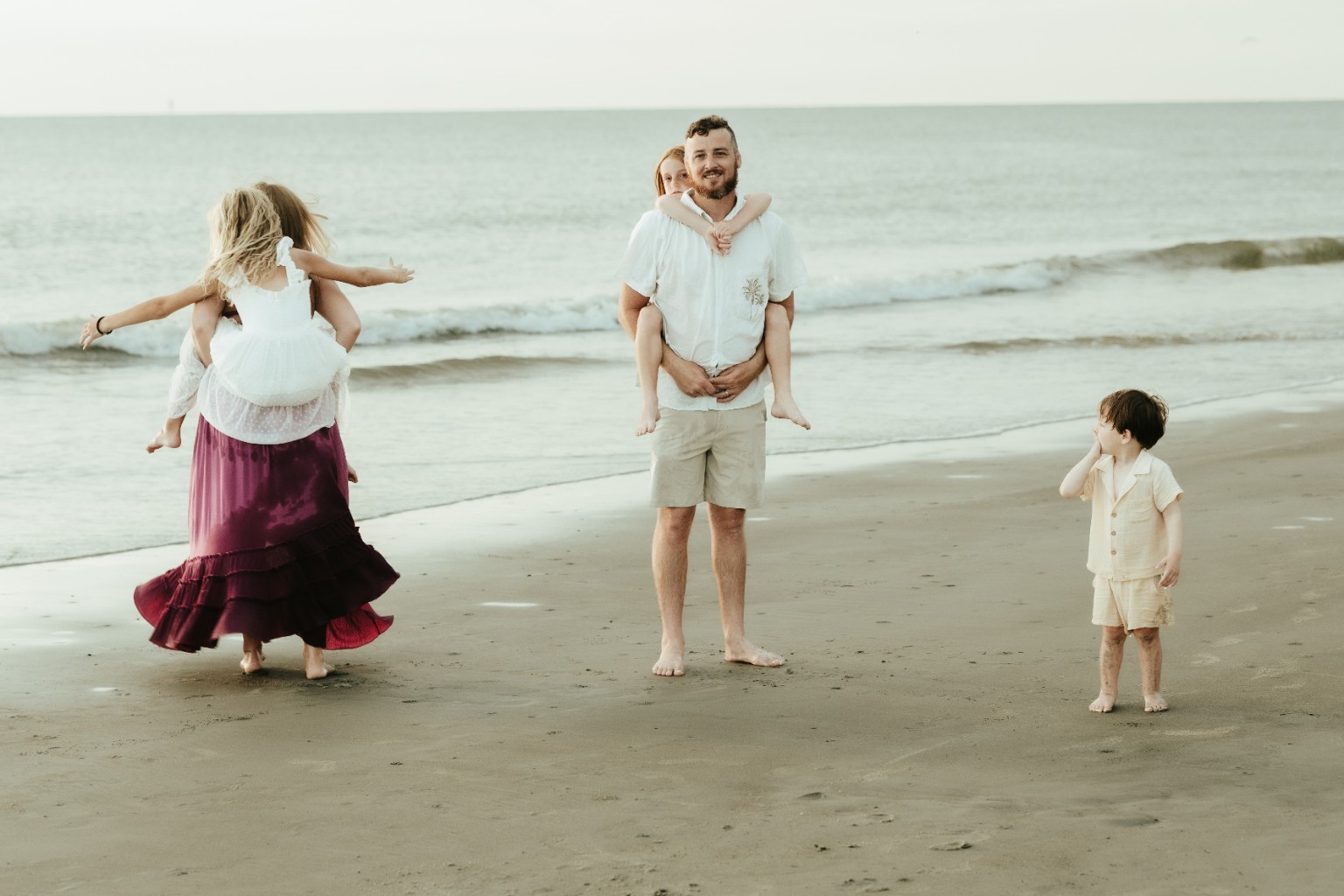 The McCormick family laughing and playing on the beach