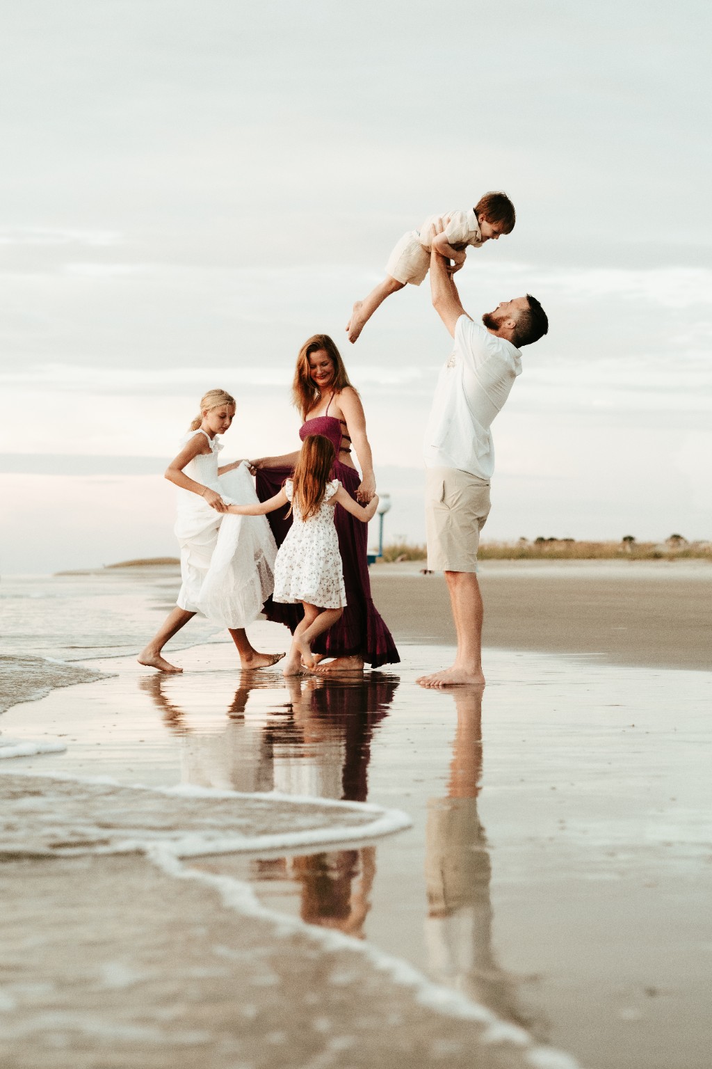 The McCormick family playing together at the water's edge