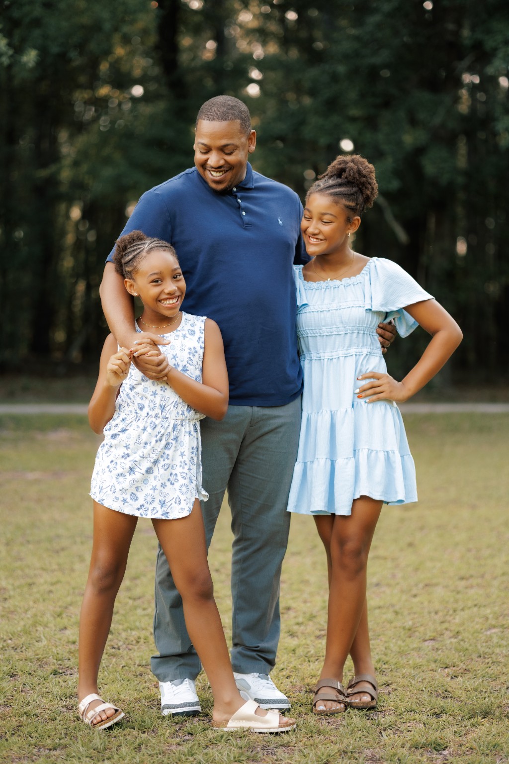 A father sharing a playful moment with his daughters
